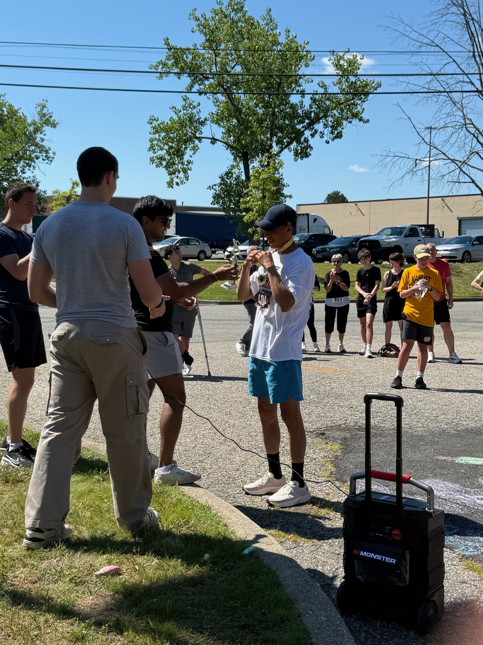 A finisher wearing a medal being photographed by a friend after the Heart of Gold 5K.