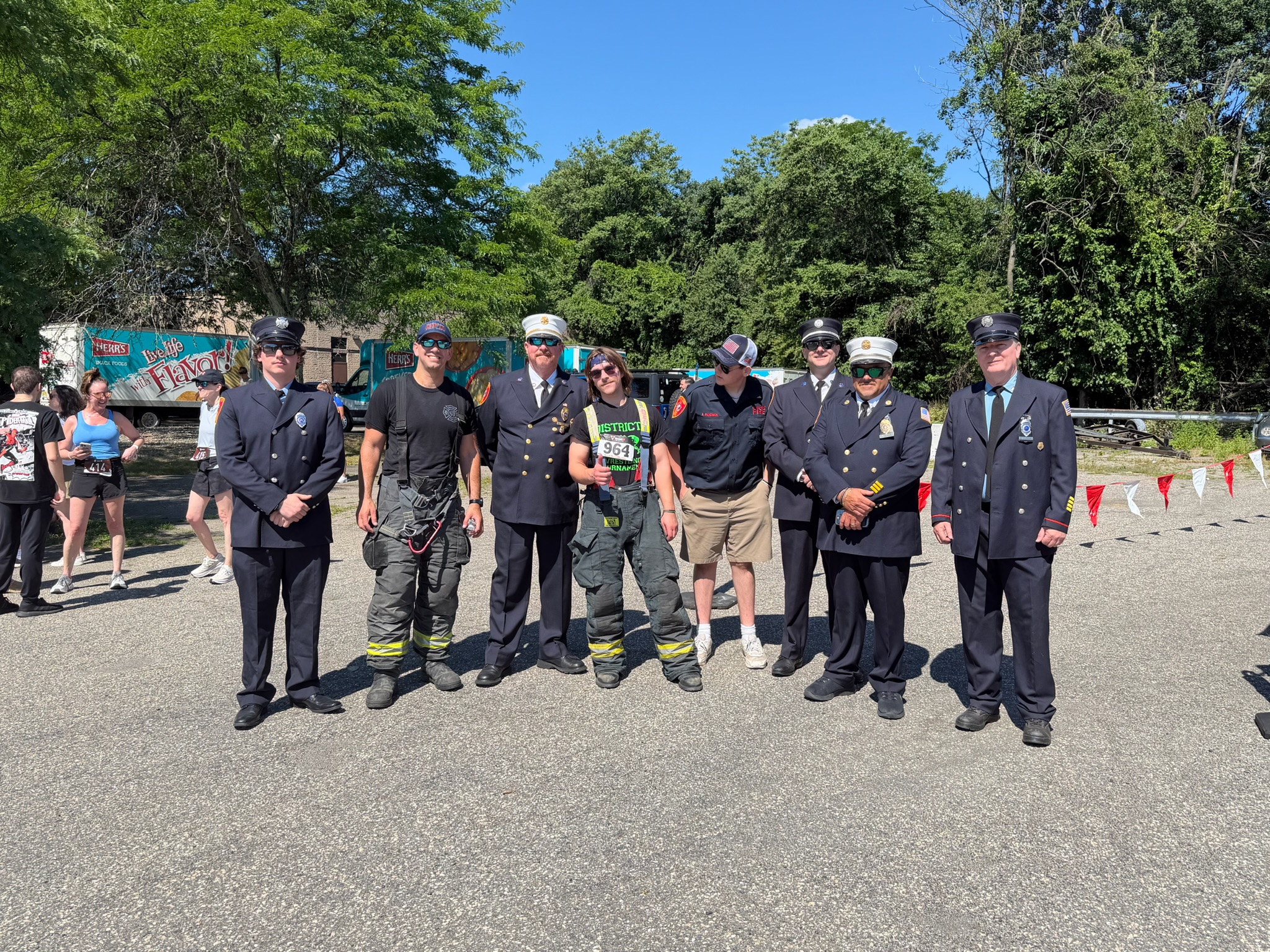 Uniformed firefighters and officers lined up together at the Heart of Gold 5K in Oakland, New Jersey.