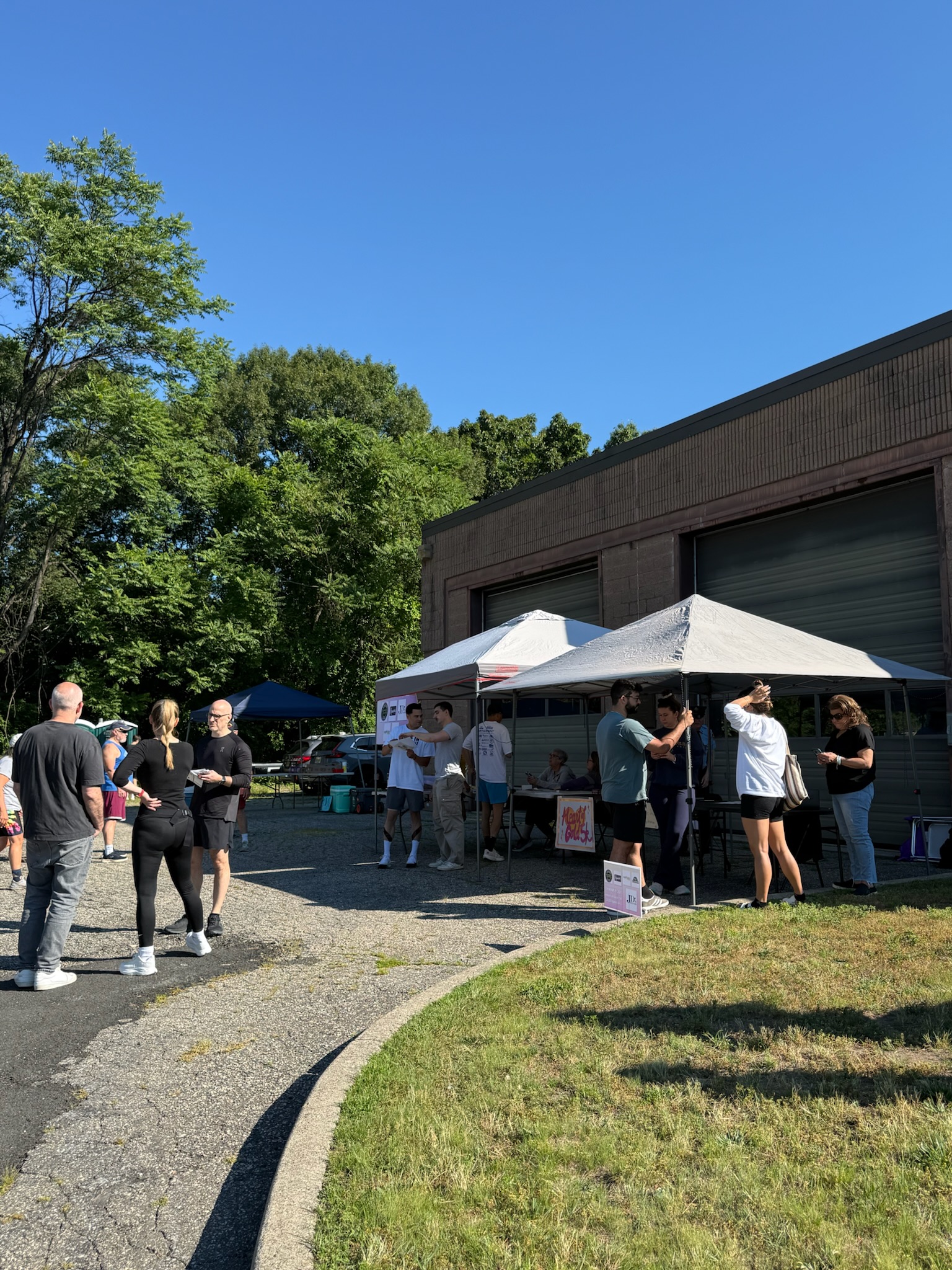 Wide view of the event area with tents and participants at the Heart of Gold 5K.
