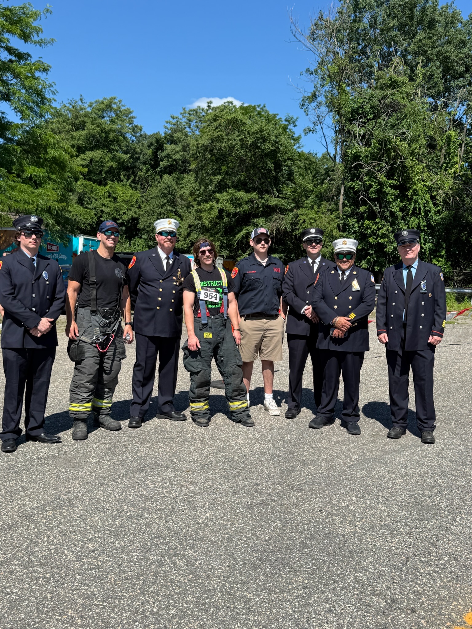 A group of uniformed first responders posing together on the street at the Heart of Gold 5K.