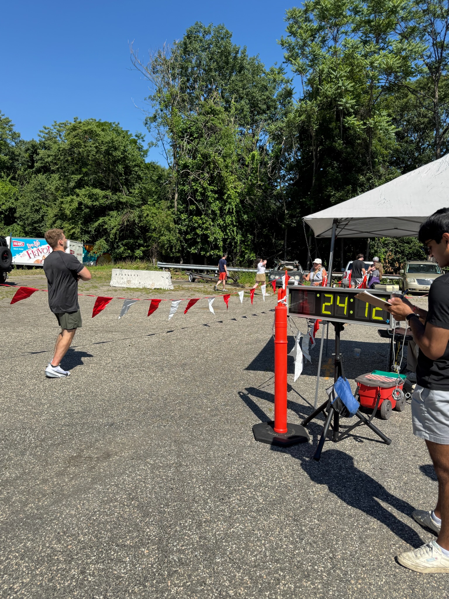A runner approaching the finish area next to the digital race clock at the Heart of Gold 5K.