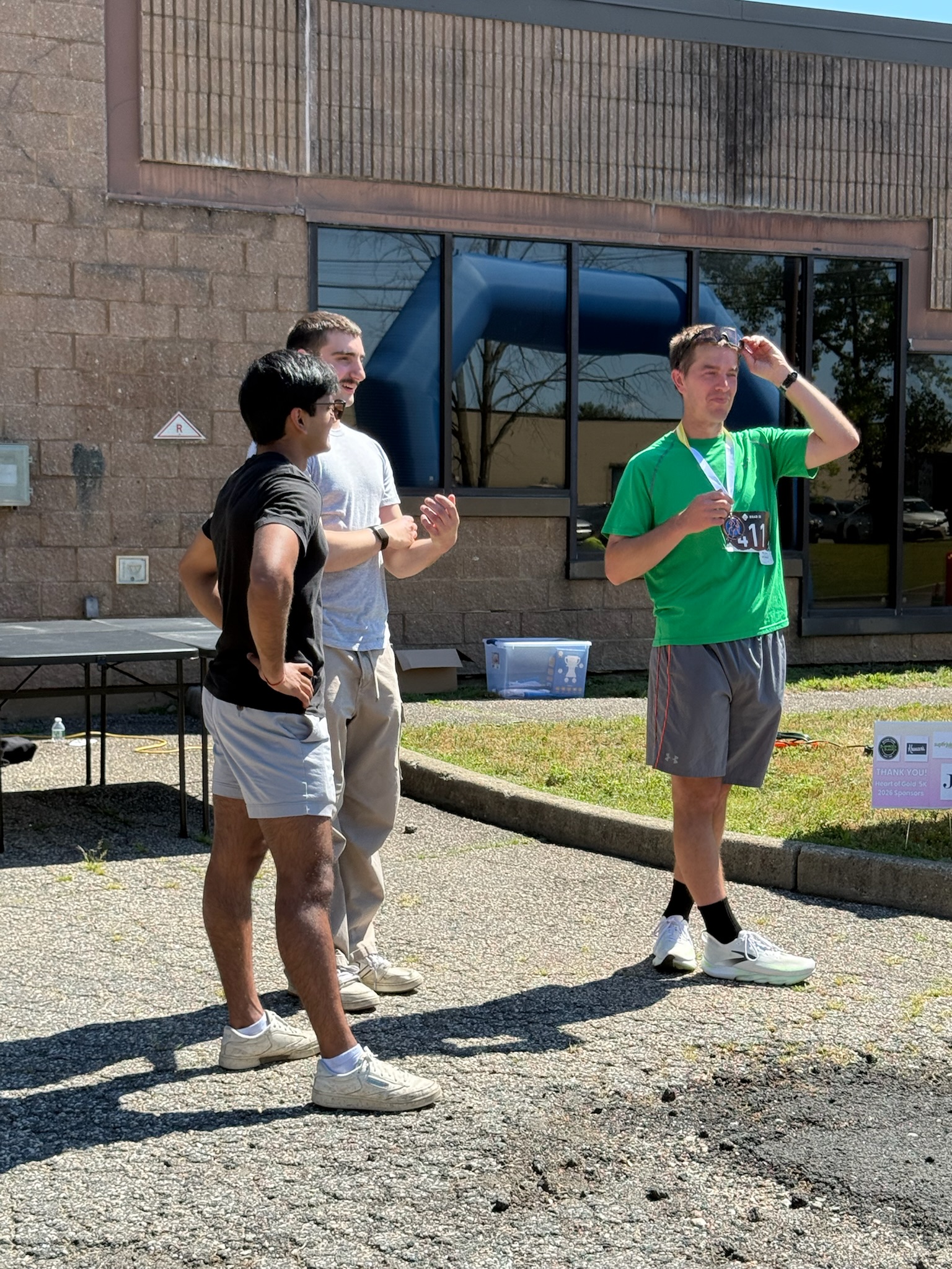 Two race participants talking outside the event area at the Heart of Gold 5K.